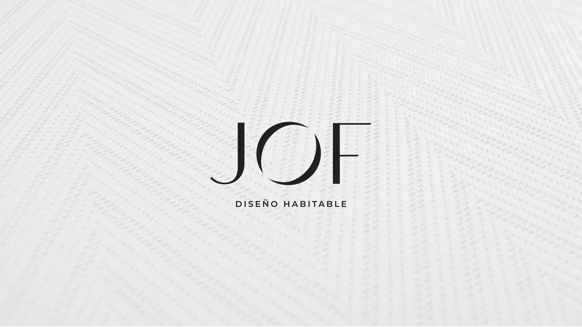 Logotipo de JOF Diseño Habitable sobre una alfombra de textura espigada blanca